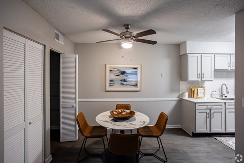 A dining room with a table set for two and a ceiling fan. at The Grove Brentwood, Nashville, TN 37211 